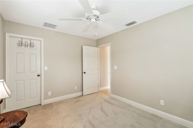 unfurnished bedroom featuring ceiling fan and light colored carpet