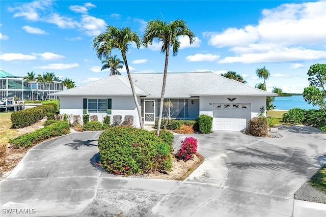 980 Iris Ct, Marco Island, FL 34145 - ranch-style house featuring an attached garage, concrete driveway, and stucco siding