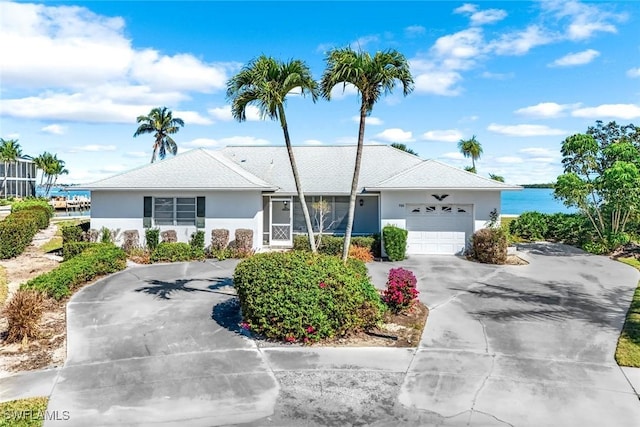 980 Iris Ct, Marco Island, FL 34145 - ranch-style home featuring an attached garage, driveway, and stucco siding