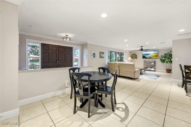 dining space featuring ornamental molding and light tile patterned flooring