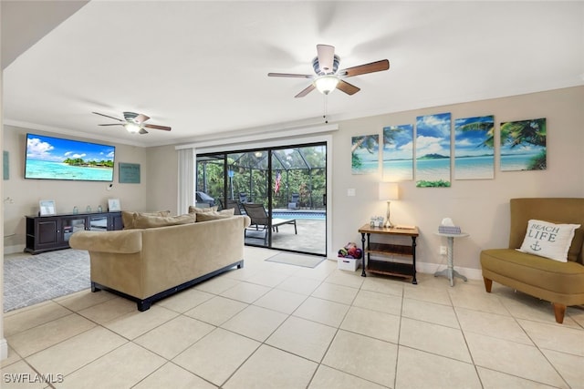 living room featuring light tile patterned floors, ornamental molding, and ceiling fan