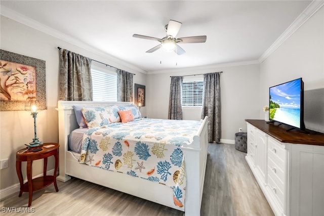 bedroom with crown molding, ceiling fan, and light hardwood / wood-style flooring