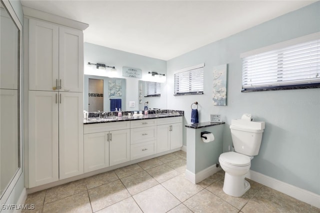 bathroom featuring vanity, toilet, and tile patterned flooring