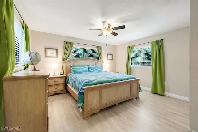 bedroom with ceiling fan and light hardwood / wood-style flooring