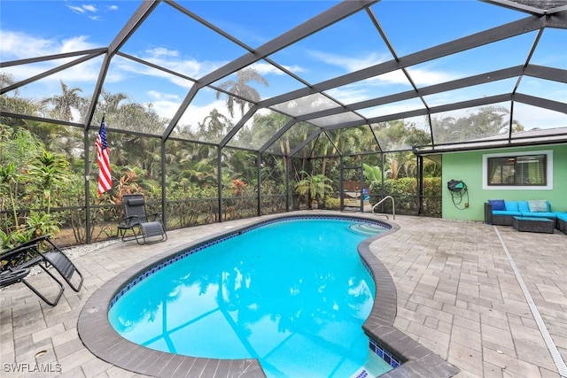 view of pool with a lanai and a patio