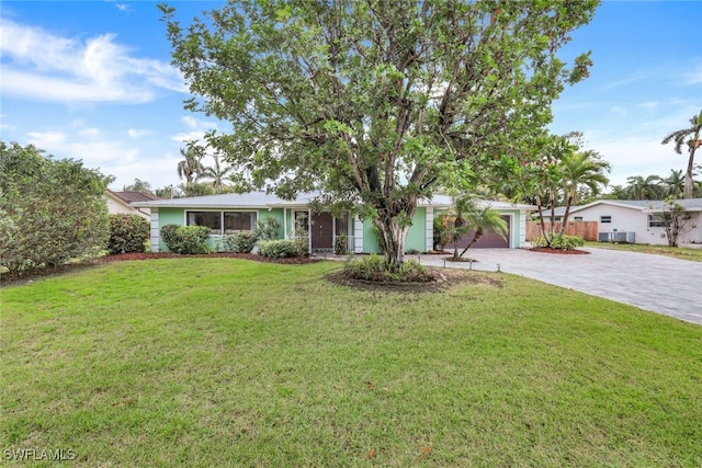 single story home with a garage and a front yard