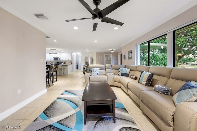 tiled living room featuring ornamental molding and ceiling fan