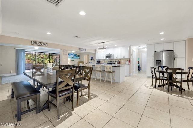 tiled dining space with crown molding