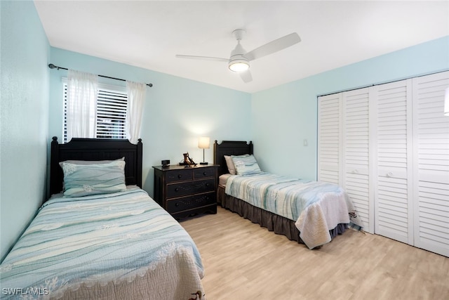 bedroom with light hardwood / wood-style flooring, a closet, and ceiling fan