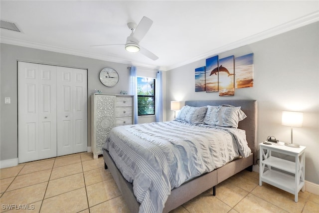 bedroom featuring ornamental molding, a closet, ceiling fan, and light tile patterned flooring