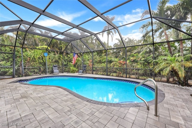 view of pool featuring a patio area and glass enclosure