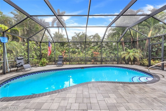 view of swimming pool with a patio and glass enclosure