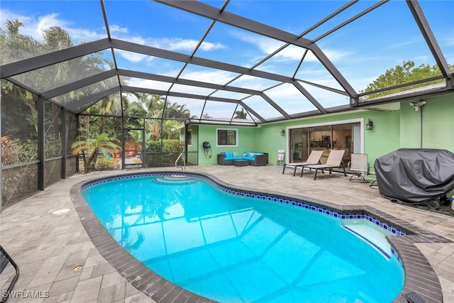 view of pool with a grill, a lanai, an outdoor living space, and a patio area