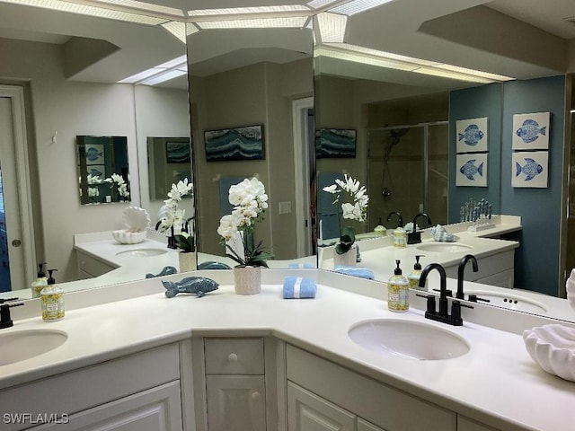 bathroom featuring vanity and a shower with shower door