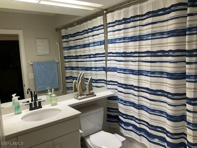 bathroom with vanity, toilet, and curtained shower