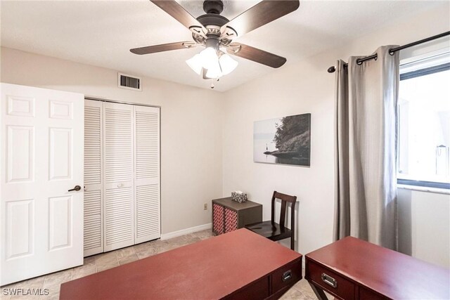 office area with light tile patterned flooring and ceiling fan