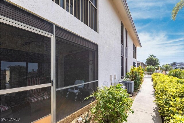 view of side of property with central air condition unit