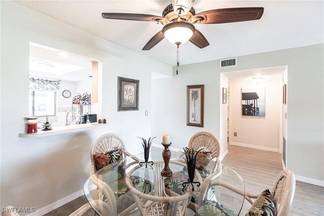 dining space featuring ceiling fan and light hardwood / wood-style flooring