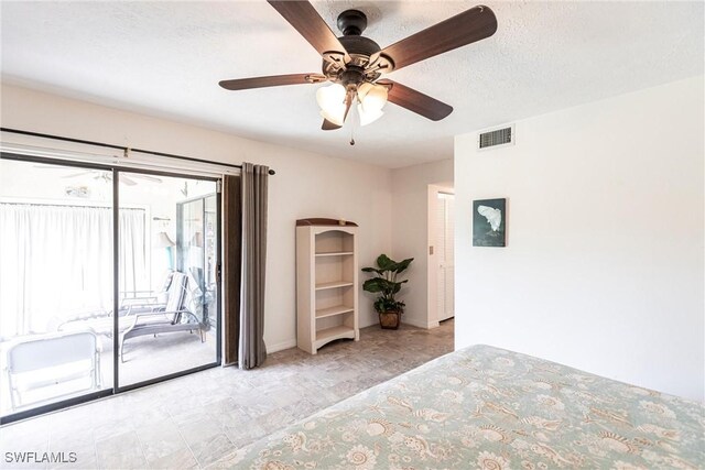 unfurnished bedroom featuring a textured ceiling, access to exterior, and ceiling fan