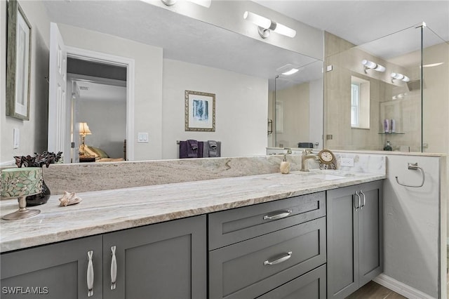 bathroom with vanity and a tile shower