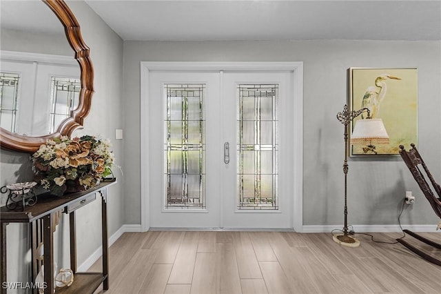 doorway to outside featuring french doors, a wealth of natural light, and light hardwood / wood-style flooring