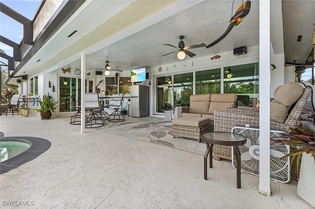 view of patio / terrace featuring ceiling fan and an outdoor living space