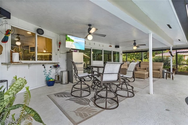 view of patio / terrace featuring ceiling fan and an outdoor living space