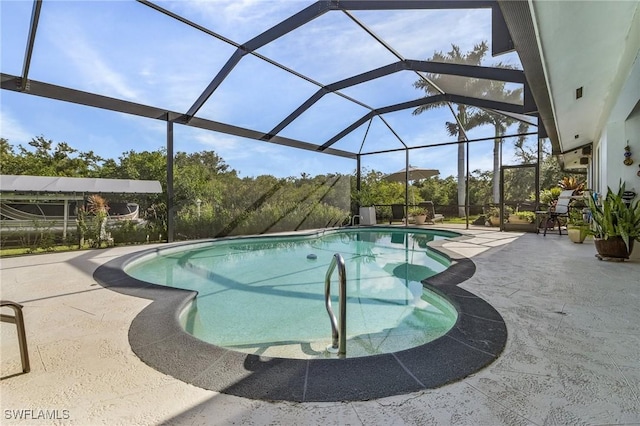 view of pool featuring a patio and glass enclosure