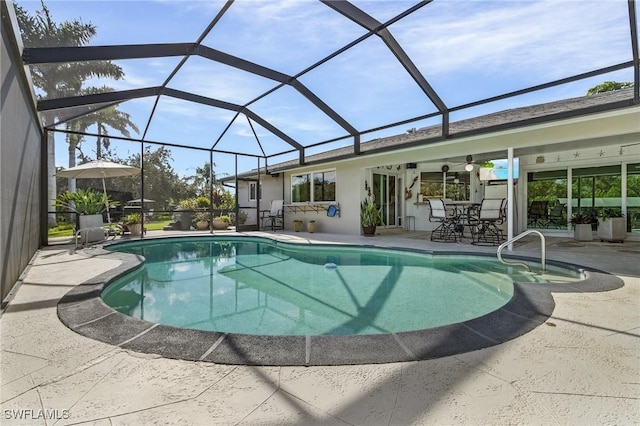 view of pool featuring a patio and glass enclosure