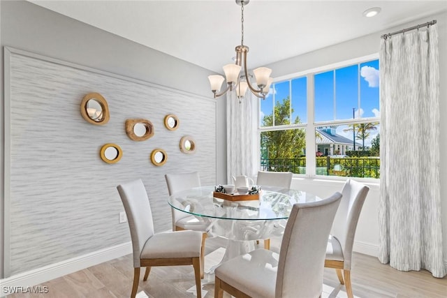 dining room featuring a notable chandelier and light hardwood / wood-style flooring