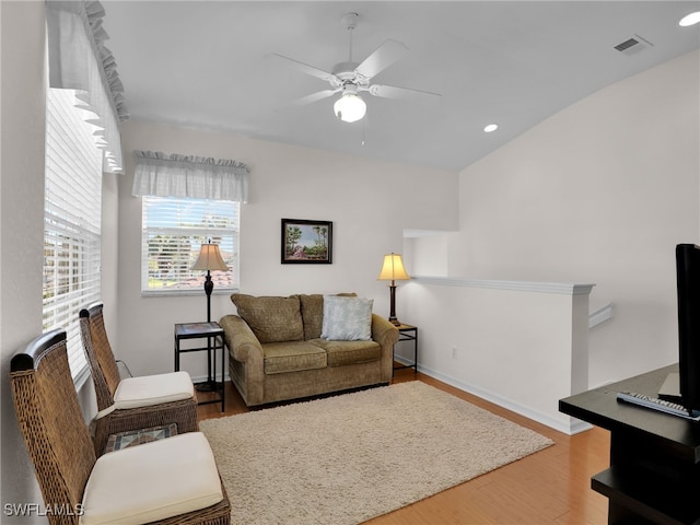 living room with hardwood / wood-style floors and ceiling fan