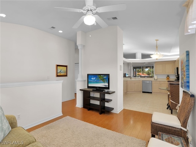 living room featuring ceiling fan and light hardwood / wood-style floors