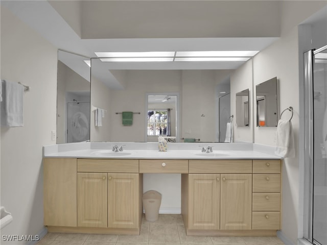 bathroom featuring vanity, a shower with shower door, and tile patterned flooring