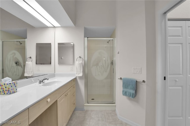 bathroom featuring an enclosed shower, vanity, and tile patterned floors