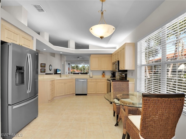 kitchen featuring pendant lighting, sink, stainless steel appliances, light tile patterned flooring, and light brown cabinetry