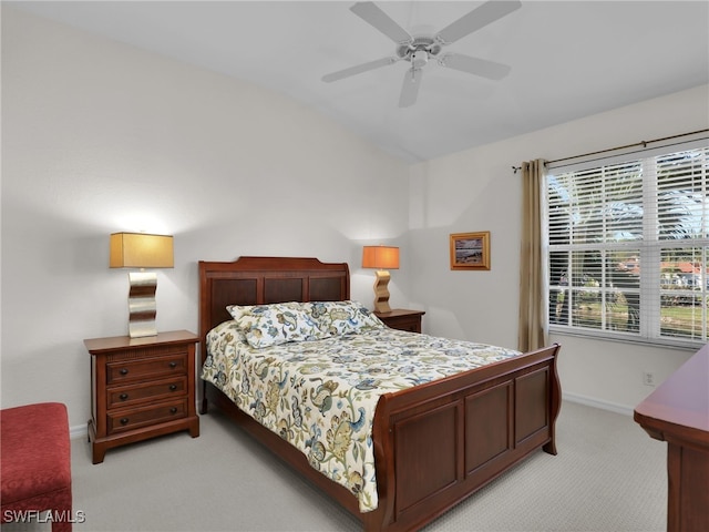 bedroom with vaulted ceiling, light colored carpet, and ceiling fan