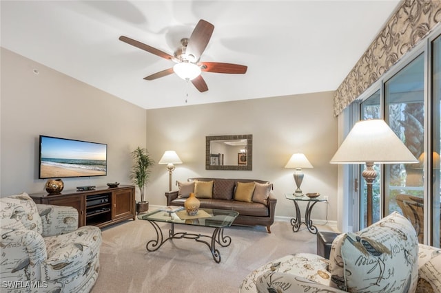 carpeted living room featuring ceiling fan and a wealth of natural light