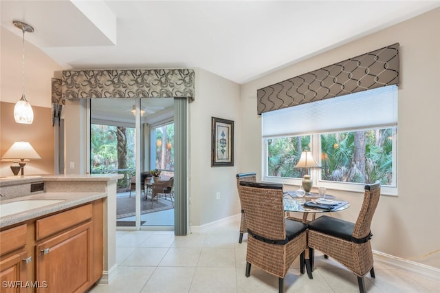 tiled dining room featuring sink