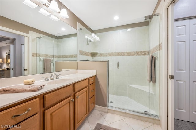 bathroom with vanity, tile patterned floors, and a shower with door