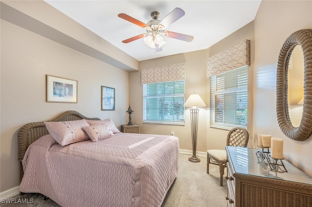 bedroom with ceiling fan and light colored carpet