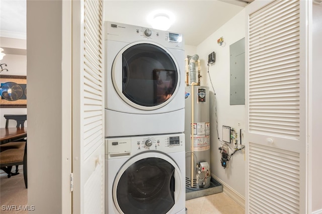 washroom featuring gas water heater, electric panel, and stacked washing maching and dryer