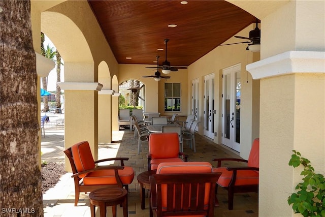 view of patio / terrace featuring ceiling fan and french doors