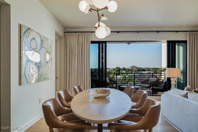 dining space featuring an inviting chandelier, plenty of natural light, and light hardwood / wood-style flooring