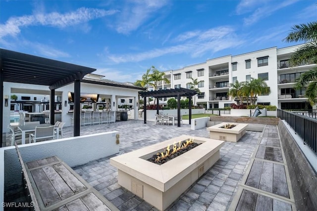 surrounding community with a patio, a fire pit, and a pergola