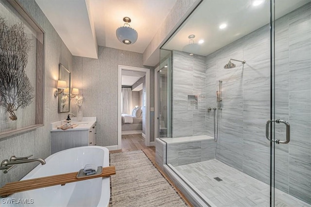 bathroom with hardwood / wood-style floors, an enclosed shower, and vanity