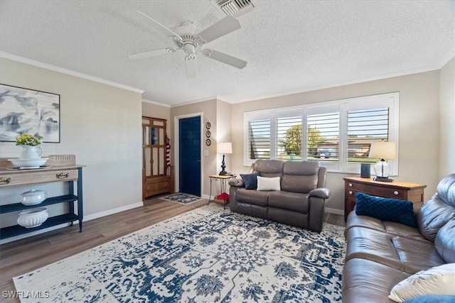 living room with dark hardwood / wood-style flooring, ceiling fan, crown molding, and a textured ceiling