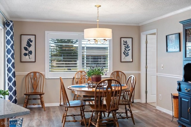 dining area with crown molding, hardwood / wood-style floors, and a textured ceiling