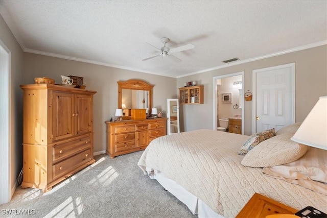 carpeted bedroom with ceiling fan, crown molding, a textured ceiling, and ensuite bathroom