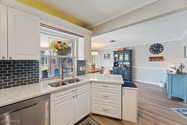 kitchen featuring white cabinetry, sink, ornamental molding, and stainless steel dishwasher