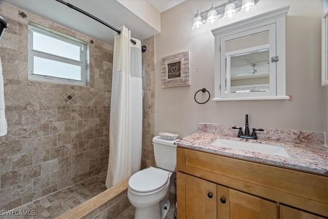 bathroom featuring walk in shower, vanity, and toilet